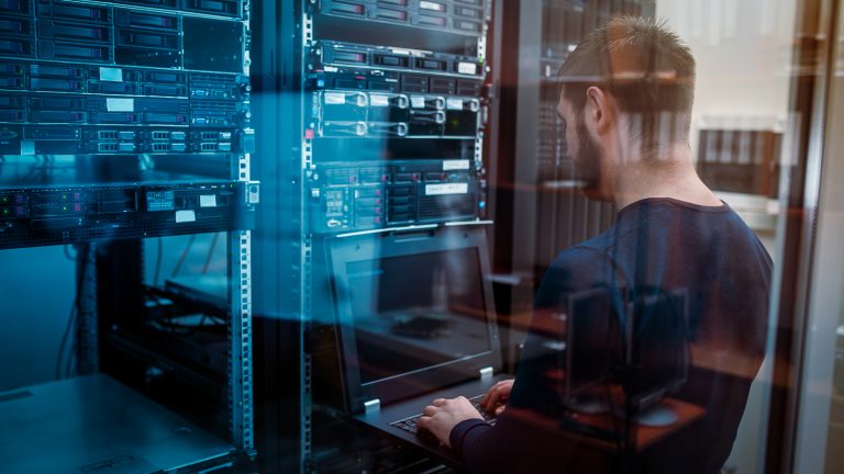 IT manager at dealership is working in the server room