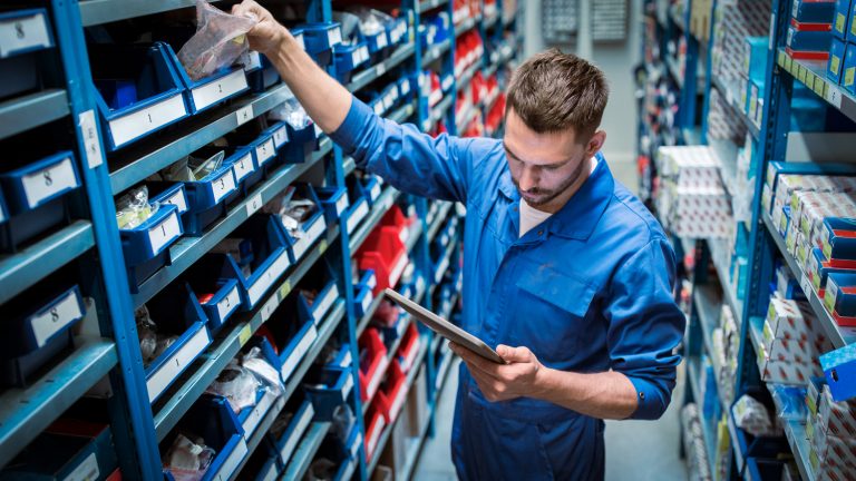 auto mechanic man with tablet looking for spares at workshop or warehouse